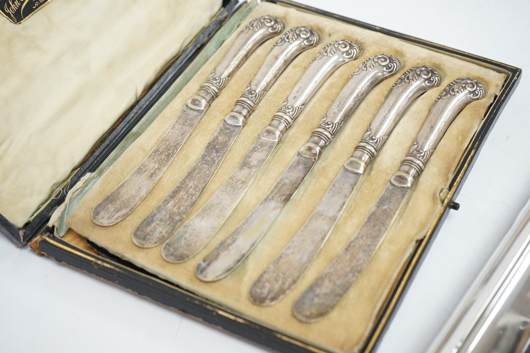A George V silver mounted photograph frame, by A & J Zimmerman, Birmingham, 1923, 25.7cm, one other modern silver mounted photograph frame and a cased set of six silver handled tea knives. Condition - poor to fair